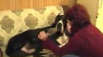 Aroused mature gets intimate with the dog while being filmed