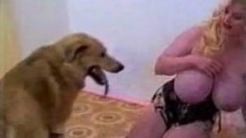 Absurdly busty blonde takes dog cock from behind