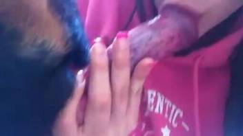 Pink outfit hottie swallows up a dog's red penis
