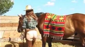 Woman in white stockings penetrated by a horse outside