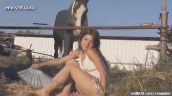 Young girl in a gown modeling beside an attractive stallion